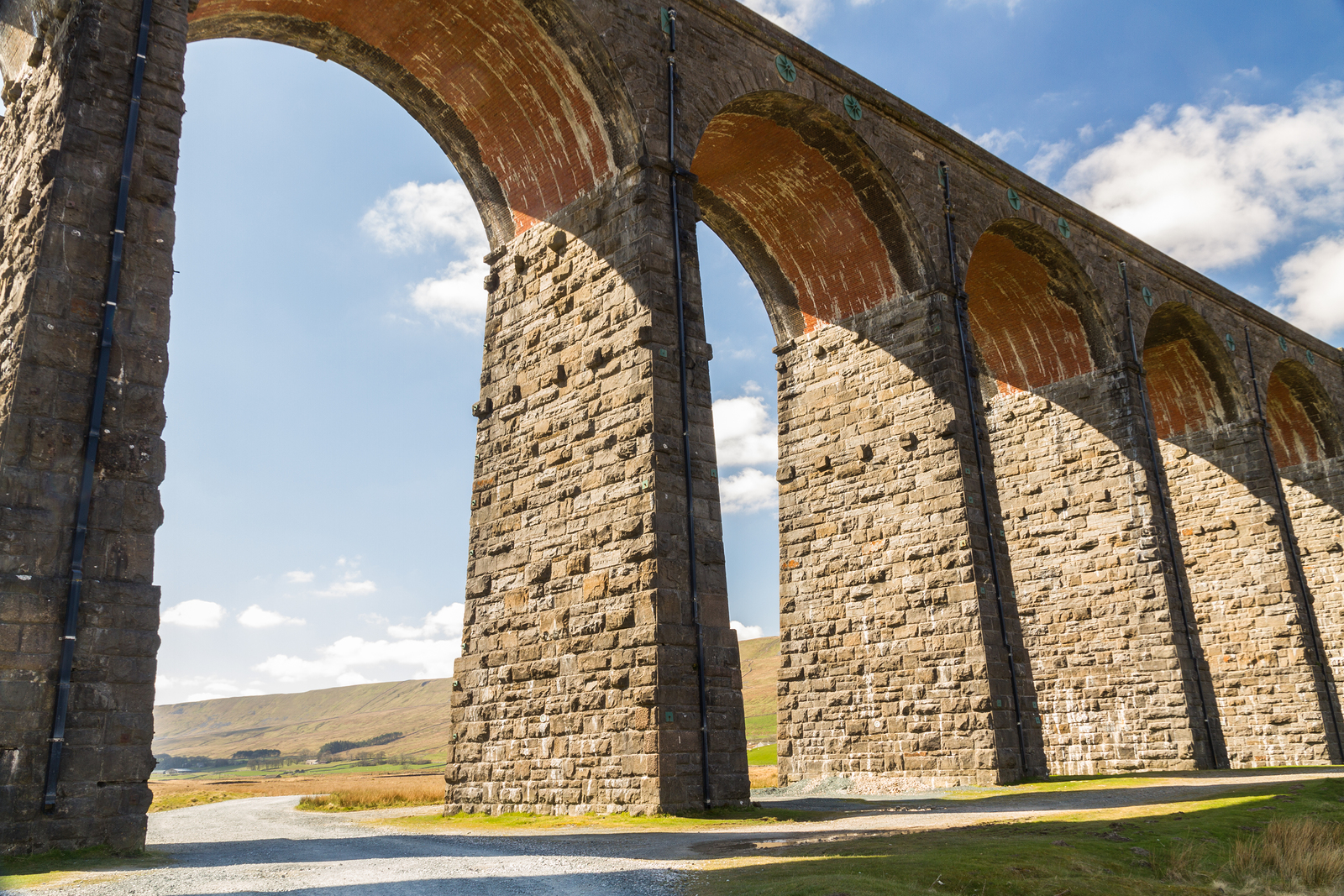 Towering Sunlit Arches Of A Railway Viaduct