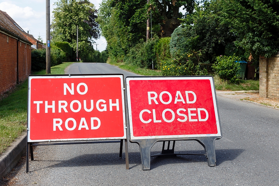Road signs showing a street closed in the UK