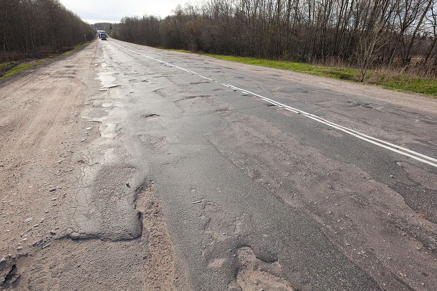 Bad Quality Road With Potholes. Hole In Asphalt, Bad Asphalt. Pi