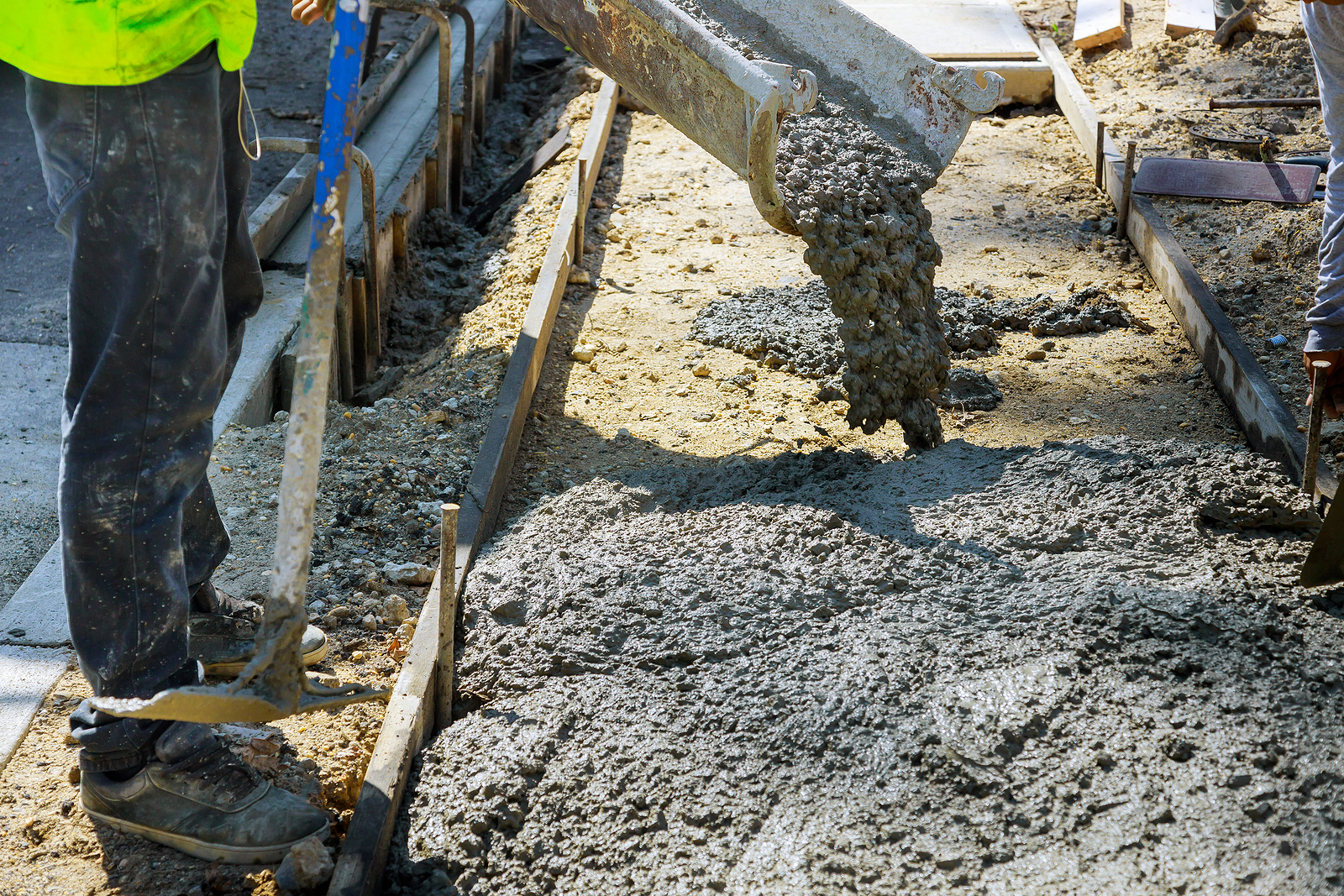 Construction Worker Pour Cement For Sidewalk In Ttuck Mixer Pour